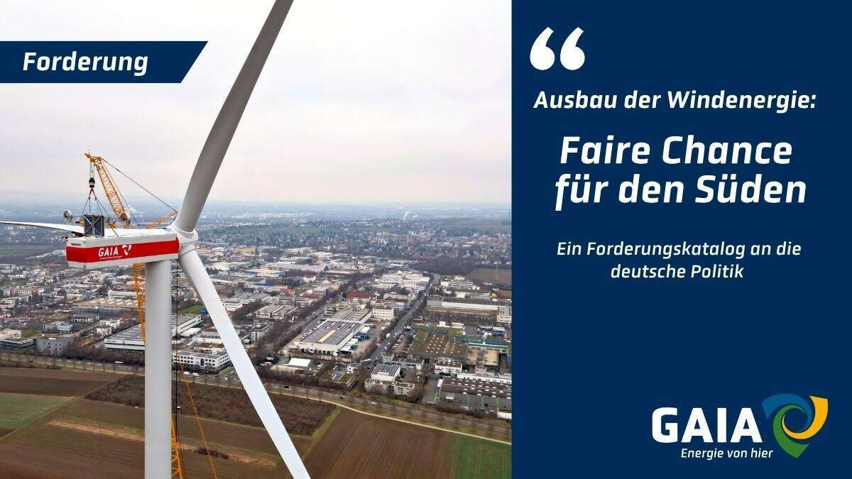 Windkraftanlage von GAIA über dem Stadt- und Gewerbegebiet bei Mainz mit der Botschaft: „Forderung – Faire Chance für den Süden“.